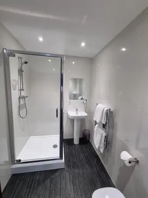 a bathroom with a shower and a sink at Premier Lodge in Falkirk