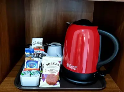 a tray with a red coffee maker and some food at Premier Lodge in Falkirk