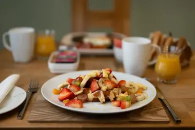 a plate of food with fruit on a table at The Trout Fly Guest House in Port Ellen