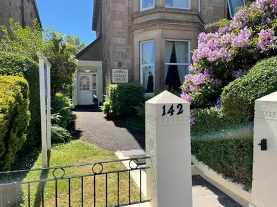 a house with a gate with the number on it at Glades House in Glasgow