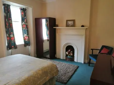 a bedroom with a fireplace and a bed in a room at The Gardener's House in Covington