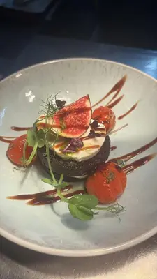 a plate of food with vegetables on a table at The Gardener's House in Covington