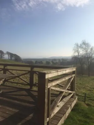 a wooden fence in the middle of a field at The Gardener's House in Covington