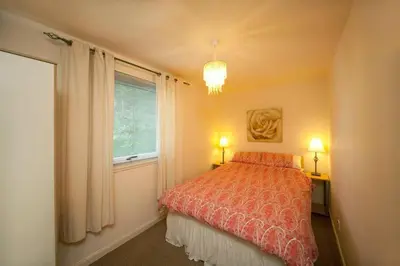a bedroom with a bed and a window at 3 Albany Apartments - Oban in Oban