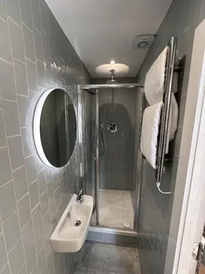 a bathroom with a shower and a sink and a mirror at The Valentine - Townhouse Hotel - Adults Only in Edinburgh