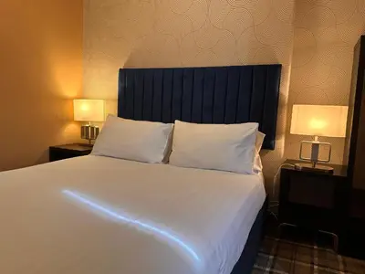 a bedroom with a large white bed with two lamps at The Valentine - Townhouse Hotel - Adults Only in Edinburgh