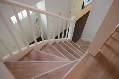 a spiral staircase with a wooden floor and a stair case at Dalveich Cottage, hot tub, 2 bedroom, Lochearnhead in Lochearnhead