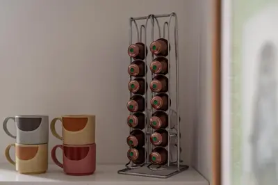 a bunch of donuts in a rack next to two cups at Dalveich Cottage, hot tub, 2 bedroom, Lochearnhead in Lochearnhead