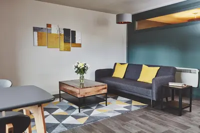 a living room with a couch and a table at The Ranald Apartments in Oban