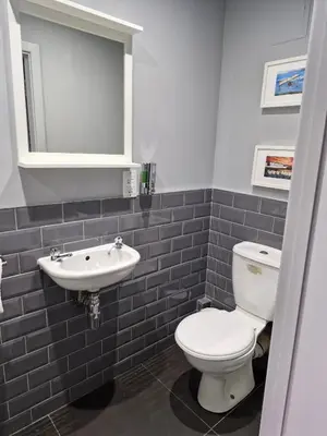 a bathroom with a toilet and a sink at The Ranald Apartments in Oban