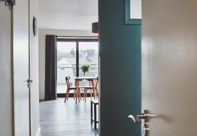 a kitchen and dining room with a table and chairs at The Ranald Apartments in Oban