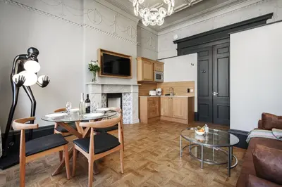 a living room with a table and a couch at Bonnie Hotel - Smart Boutique ApartHotel - Haymarket Edinburgh in Edinburgh