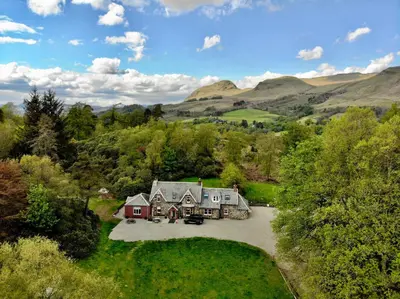 an aerial view of a house in the hills at The West Highland Way Hotel and Retreat Accommodation in Glasgow