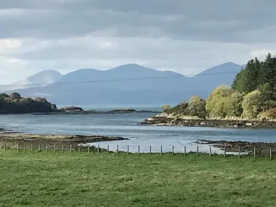 a view of a river with mountains in the background at The West Highland Way Hotel and Retreat Accommodation in Glasgow