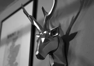 a metal sculpture of a deer on a wall at Loch Leven Hotel & Distillery in Glencoe