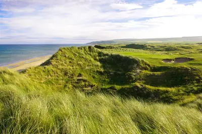 a view of a golf course with the ocean in the background at The Royal Hotel Campbeltown in Campbeltown