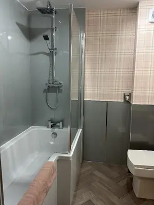a bathroom with a shower and a tub and a toilet at Eliza House in Edinburgh