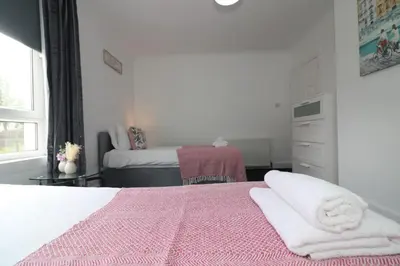 a bedroom with a bed with towels on it at Signature - Gartlea House in Airdrie