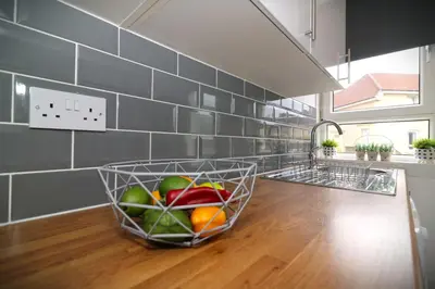 a basket of fruit on a counter in a kitchen at Signature - Gartlea House in Airdrie