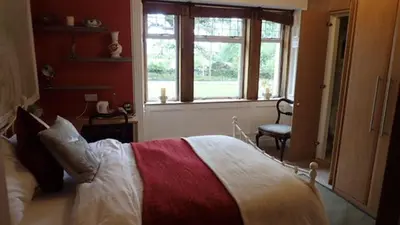 a bedroom with a bed and a window at Arrochoile in Balmaha