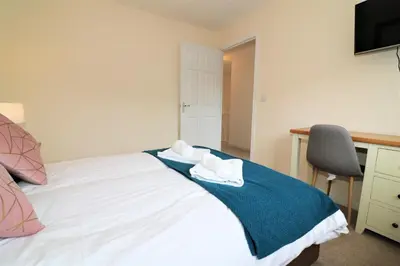 a bedroom with a bed with two towels on it at Signature - Morrison House in Glasgow