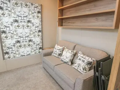 a living room with a couch with two pillows at Avonal Lodge 24 in Perth
