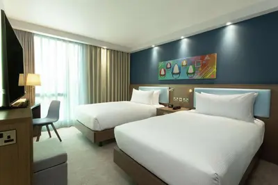a hotel room with two beds and a television at Hampton By Hilton Hamilton Park in Hamilton