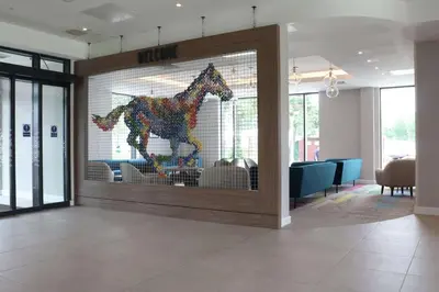 a glass door with a horse on it in a lobby at Hampton By Hilton Hamilton Park in Hamilton