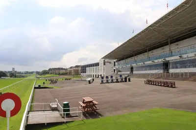 a view of a stadium with picnic tables and benches at Hampton By Hilton Hamilton Park in Hamilton