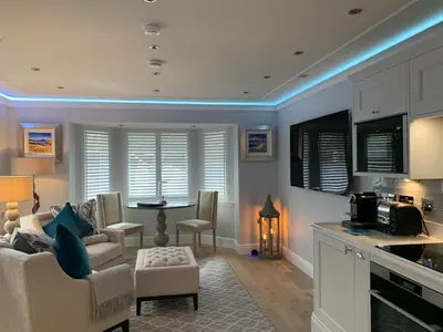 a kitchen and living room with a couch and a table at Bagpipers Luxury Hideaway Glencoe Ballachulish Highlands Near Fort William in Glencoe