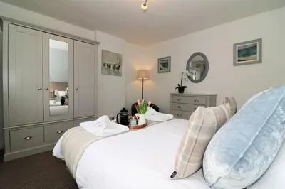 a bedroom with a white bed and a mirror at Signature - Gordon House in Glasgow