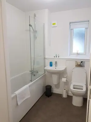 a bathroom with a toilet and a sink and a shower at 1 Royal View Apartments in Stirling