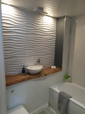 a bathroom with a sink and a mirror and a tub at Boutique Coastal appt nr Edinburgh in Saint Davids