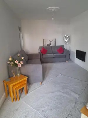 a living room with a couch and a table at The old post office Callander holiday let in Callander