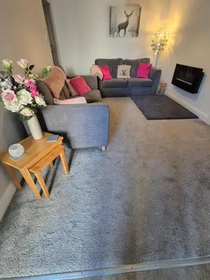 a living room with a couch and a table at The old post office Callander holiday let in Callander