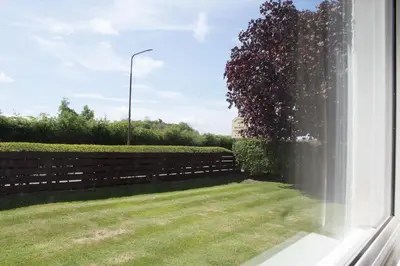 a window view of a yard with a fence at Whitecroft B&B in Edinburgh