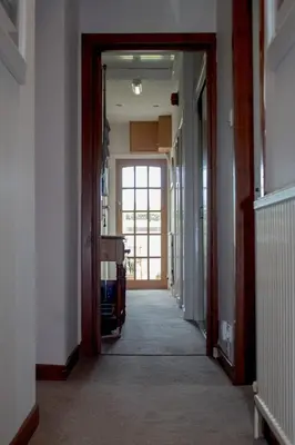 a hallway with a door open to a room with a hallwayngthngthngthngth at Whitecroft B&B in Edinburgh