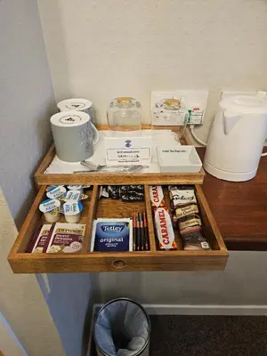 a wooden shelf with food and other items on it at Whitecroft B&B in Edinburgh