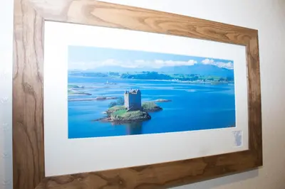 a framed picture of a castle on an island in the water at Whitecroft B&B in Edinburgh