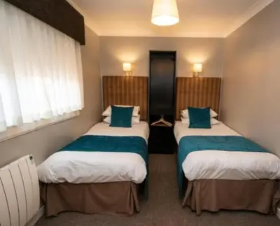 a room with two beds in a hotel room at The Georgian hotel in Coatbridge