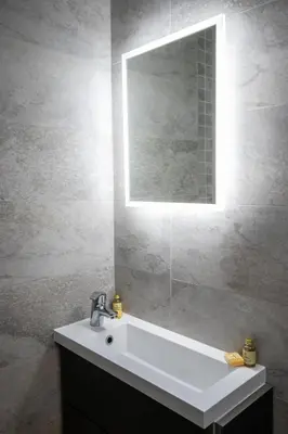 a bathroom with a white sink and a mirror at The Georgian hotel in Coatbridge