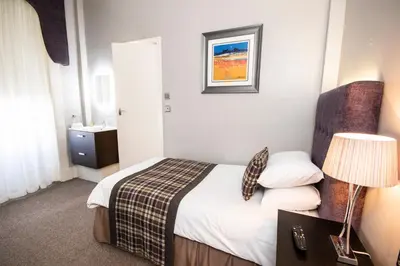 a hotel room with a bed and a sink at The Georgian hotel in Coatbridge
