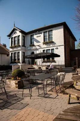a group of tables and chairs in front of a building at The Georgian hotel in Coatbridge