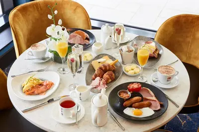 a table with plates of breakfast food on it at Dalmeny Park House Hotel in Barrhead