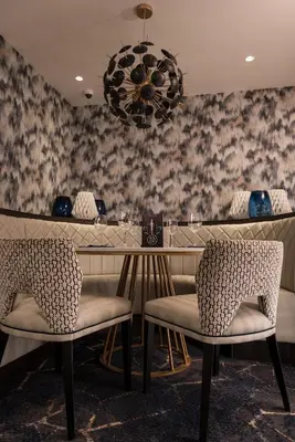 a dining room with a table and two chairs at Dalmeny Park House Hotel in Barrhead