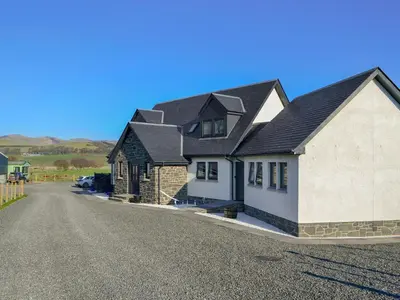 a house on a street with a driveway at Blueacres in Skirling