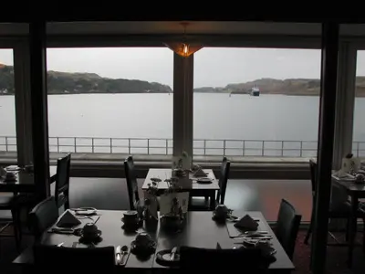 a dining room with a view of the water at Lancaster Hotel in Oban