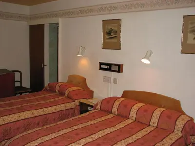 a hotel room with two beds and a window at Lancaster Hotel in Oban