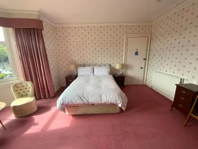 a hotel room with a bed and a window at Dunrigh Guest House in Oban