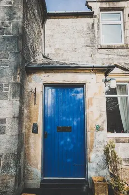 a blue door on the side of a building at Heatherfield House in Oban